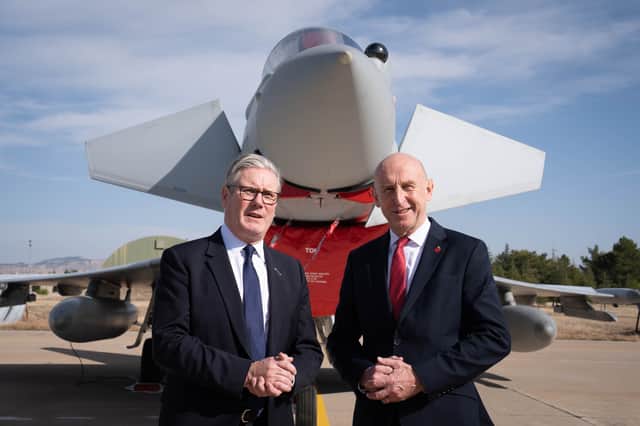 Prime Minister Sir Keir Starmer, left, and Defence Secretary John Healey stand in front of a UK Typhoon fighter jet at Tusas airbase in Ankara, during a visit to Turkey