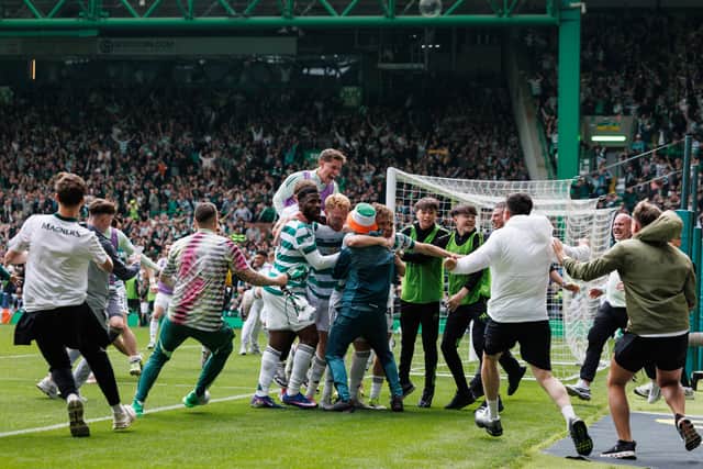 Celtic fans spill on to the pitch during the 3-1 win over Hearts.