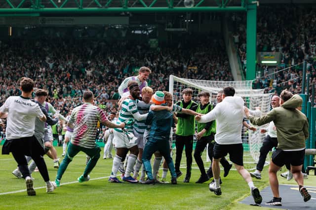 Celtic fans spill on to the pitch during the 3-1 win over Hearts.