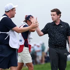 Bob MacIntyre shakes hands with caddie Mike Burrow at the end of the final round in last year’s US Open at Oakmont Country Club in Pennsylvania 