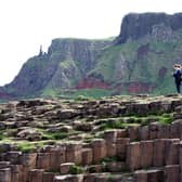 A visitor standing at the Giant's Causeway, County Antrim