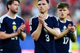 Scotland’s Andy Robertson applauds the fans after the defeat