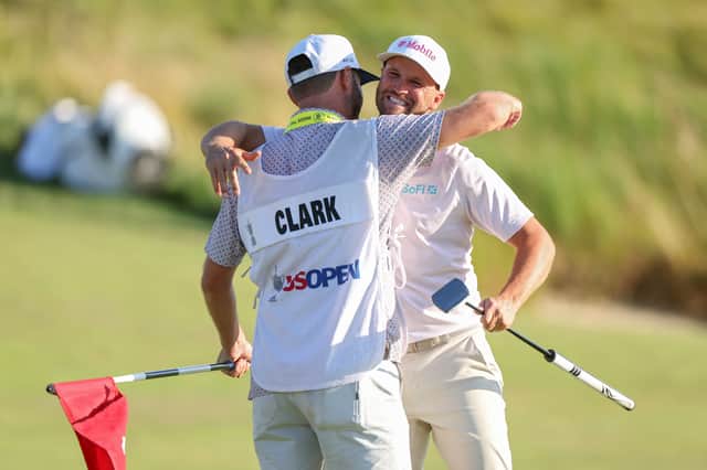 Wyndham Clark celebrates with caddie David Pelekoudas after winning his second US Open in four years 
