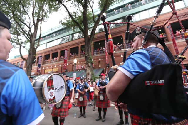 Members of Scotland's "Tartan Army" play outside of Fenway Park before a game between the Texas Rangers and the Boston Red Soxon June 14, 2026 in Boston, Massachusetts.