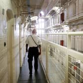 A prison guard at HMP Barlinnie. The Scottish Government is seeking to reduce the prison population, which has reached a record high in recent months, by the use of more community-based sentences. 