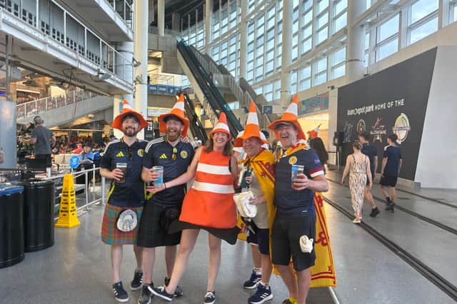 Scotland fans at the baseball wearing traffic cones