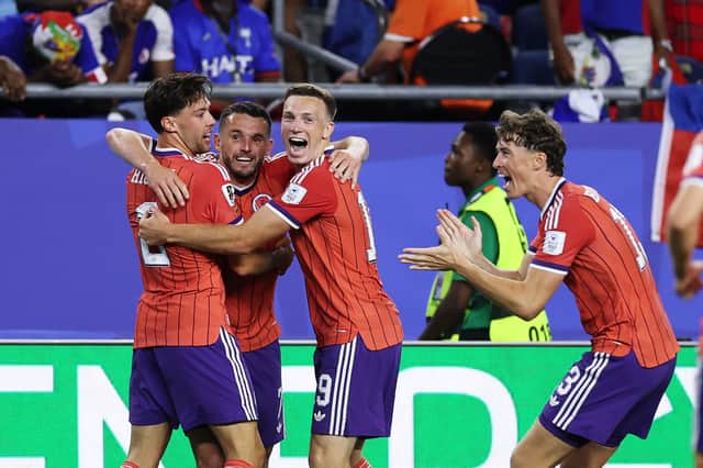 Players celebrate after John McGinn scored the winning goal in Scotland's opening World Cup match against Haiti (Picture: Justin Setterfield)