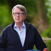 Lord Peter Mandelson taking his dog for a walk outside his home in London (PA)