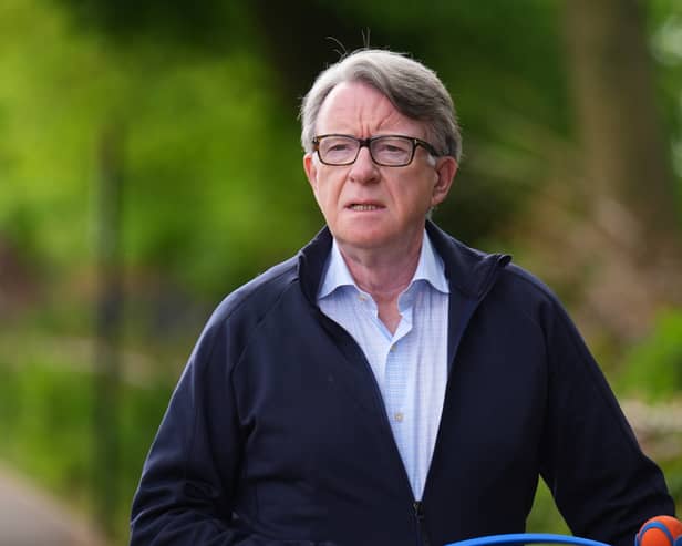 Lord Peter Mandelson taking his dog for a walk outside his home in London (PA)