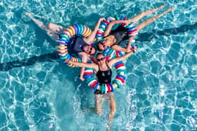 Susie MacDonald (left), Charlotte Reader (right) and Emma Ledger (centre) cool off from the hot weather at Cumnock open-air swimming pool in East Ayrshire. 