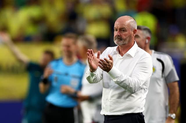 Scotland head coach Steve Clarke applauds the supporters after defeat by Brazil.