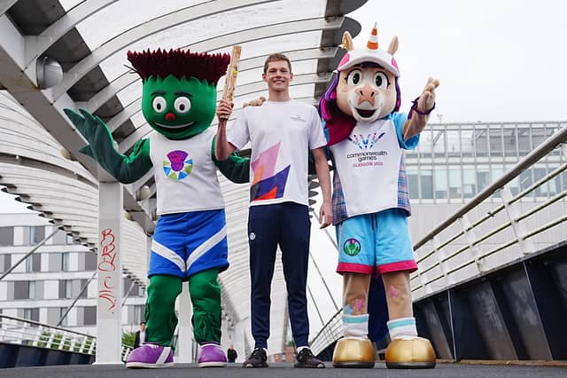 Duncan Scott with Team Scotland mascot Clyde, left, and 2026 Commonwealth Games mascot Finnie (Jane Barlow/PA)