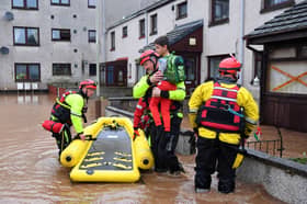 Coastguard rescue workers evacuate a family from a flooded street in Brechin during Storm Babet in 2023 (Picture: Andy Buchanan)
