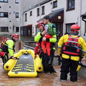 Coastguard rescue workers evacuate a family from a flooded street in Brechin during Storm Babet in 2023 (Picture: Andy Buchanan)