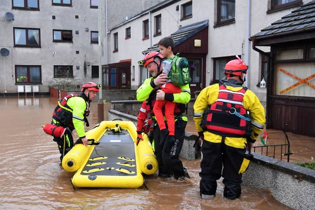 Coastguard rescue workers evacuate a family from a flooded street in Brechin during Storm Babet in 2023 (Picture: Andy Buchanan)