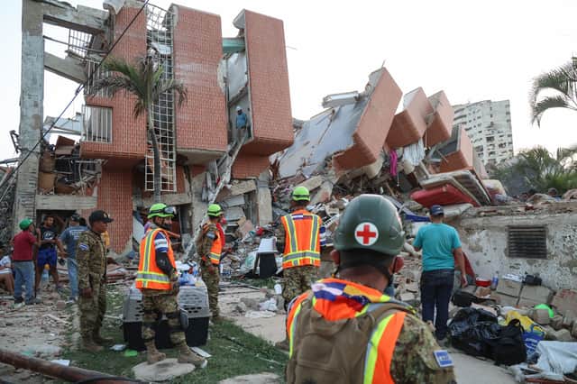 Rescuers from El Salvador search for victims amid the debris of a collapsed building in Catia La Mar (Picture: Edilzon Gamez)