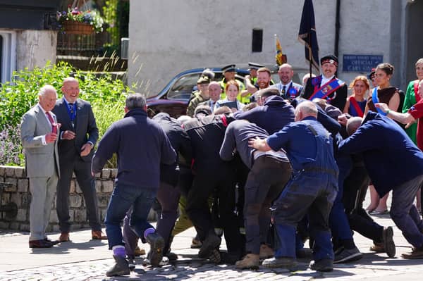 King Charles III starts a traditional game of hand ba' during his visit to Jedburgh in the Scottish Borders, as part of the King's visit to Scotland for Holyrood Week. 