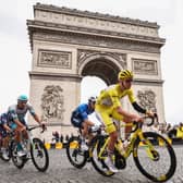 Slovenian rider Tadej Pogacar, wearing the overall leader's yellow jersey, cycles with the peloton past the Arc de Triomphe during the final stage of last year's Tour de France (Picture: Anne-Christine Poujoulat)