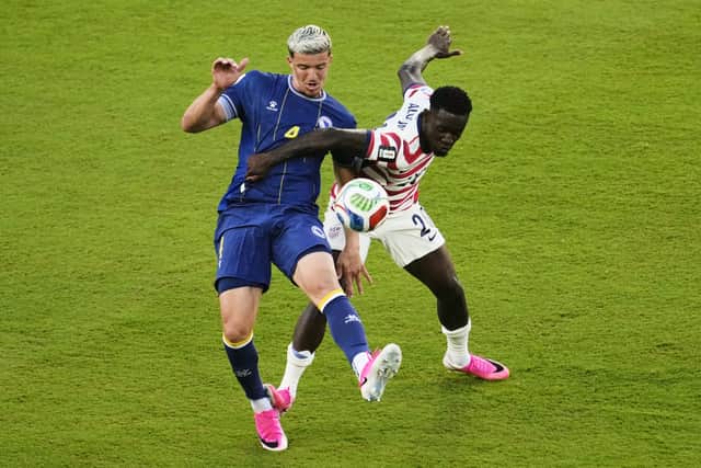 United States’ Folarin Balogun, right, was sent off for this challenge on Bosnia’s Tarik Muharemovic (Jeff Chiu/AP)