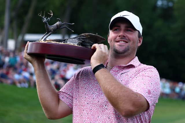 Chris Gotterup shows off the trophy after winning the John Deere Classic at TPC Deere Run in Illinois 