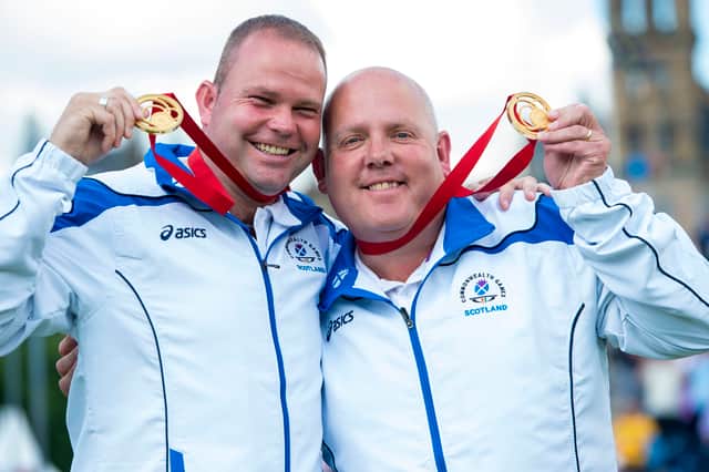 Scotland's Paul Foster and Alex Marshall show off their gold medals after their victory over Malaysia in the final of the pairs at the 2014 Commonwealth Games in Glasgow.