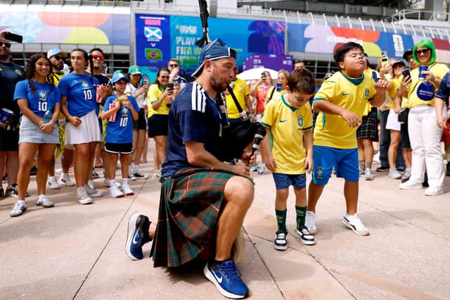 A piper performs for Brazilian fans ahead of the game in Miami (Picture: Michael Reaves)