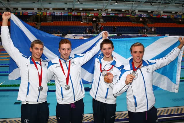 Silver medallists Stephen Milne, Dan Wallace, Duncan Scott and Robbie Renwick of Scotland after the men's 4 x 200m freestyle relay final at Tollcross the Glasgow 2014 Commonwealth Games.