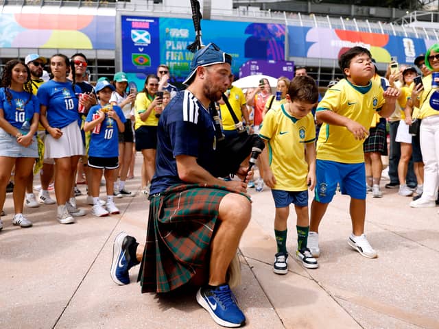 A piper performs for Brazilian fans ahead of the game in Miami (Picture: Michael Reaves)
