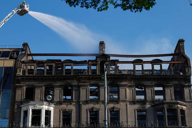 Firefighters dampen down the old Debenhams building on Edinburgh's Princes Street after a major fire broke out in the early hours of Thursday morning (Picture: Jeff J Mitchell)