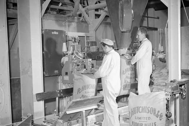 Hutchisons Flour Mill Kirkcaldy.  Men filling the bags of flour.