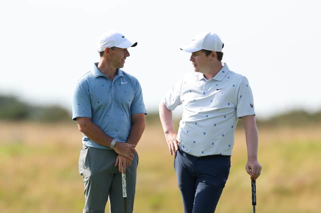 Rory McIlroy and Bob  MacIntyre chat during day two of the Genesis Scottish Open at The Renaissance Club 