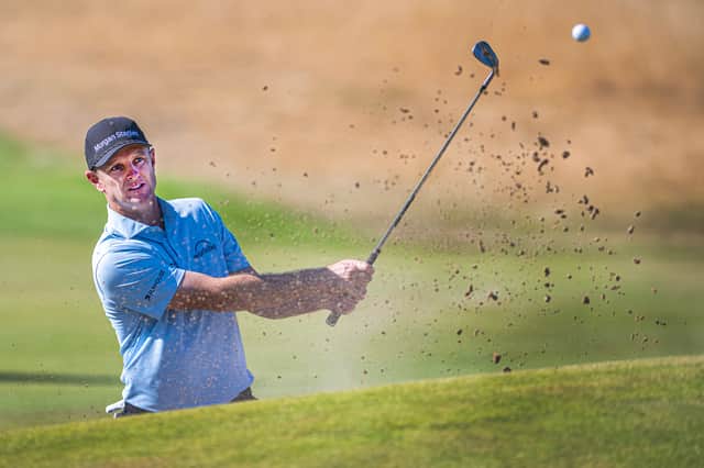 Justin Rose hits out of a bunker during his practice round for The 154th Open Championship at Royal Birkdale