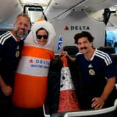 Andrew Dobbie, a member of the Delta Air Lines cabin crew, the traffic cone and Danny Campbell pose for a picture on the flight to the US