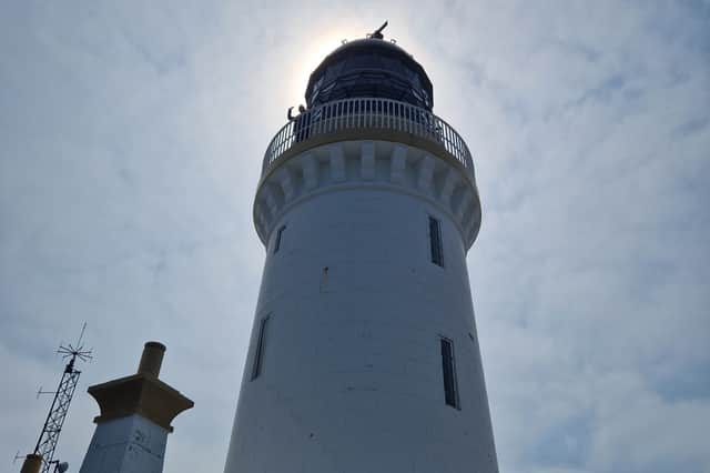 Jeri Cormack waving from Noss Head lighthouse tower