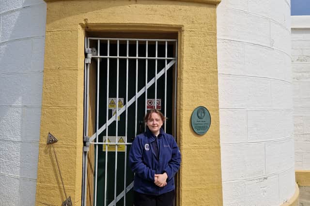 Jeri Cormack at the door of Noss Head lighthouse with its Greek pediment