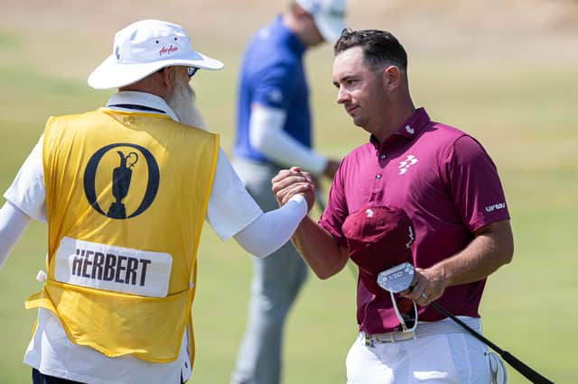 Lucas Herbert shakes hands with caddie Nick Pugh, who hails from Birkenhead, after carding his 62 in The 154th Open at Royal Birkdale
