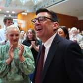 Andy Burnham, seen with his wife Marie-France van Heel, gets a round of applause as he arrives to give a speech at the Trades Union Congress (Picture: Carl Court)