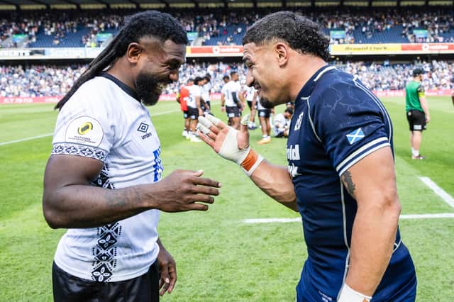 Scotland's Sione Tuipulotu (R) and Fiji's Frank Lomani at full time following the Nations Championship match between Fiji and Scotland at Scottish Gas Murrayfield.