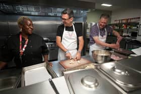 Andy Burnham chops mushrooms as he helps prepare breakfast during a visit to The Passage Homeless Charity in London on Monday morning, just hours before becoming Prime Minister (Picture: Christopher Furlong/pool)