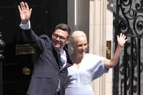 Andy Burnham waves with his wife Marie-France van Heel