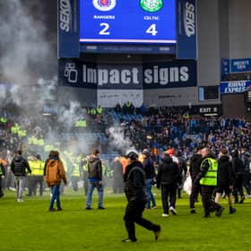 Rangers and Celtic fans storm on to the pitch during the March 8 derby at Ibrox.