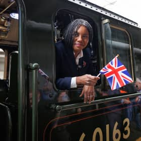 Conservative leader Kemi Badenoch waves a Union flag as she leans out of a steam locomotive at Beaulieu Park Station in Chelmsford (Picture: Dan Kitwood)