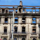 Work is under way to secure the facade of the fire-ravaged former Debenhams store