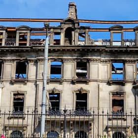 Work is under way to secure the facade of the fire-ravaged former Debenhams store