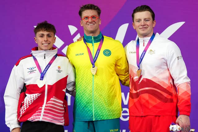 Sam Williamson, centre, took gold in the men's 100m breaststroke final.