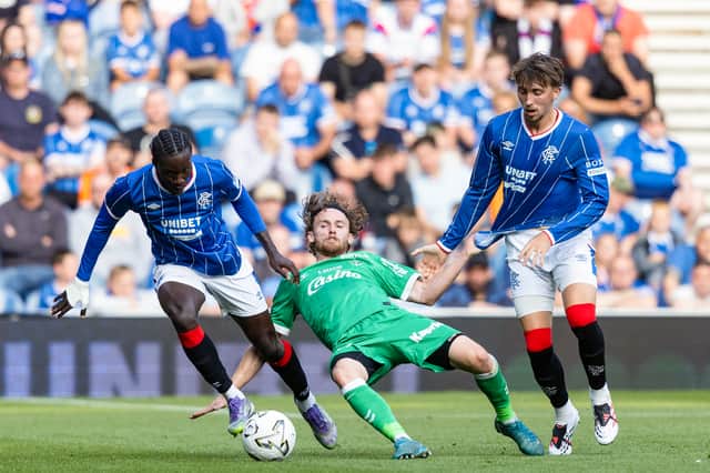 Diomande (left) has strong competition for a spot in Rangers' line-up this season after a raft of summer signings, such as Dan Neil (right).