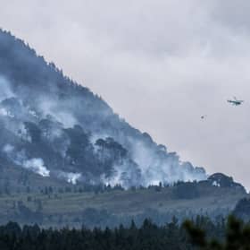 Helicopters have been tackling the devastating wildfire.