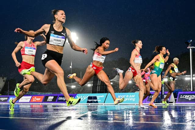 New Zealand's Zoe Hobbs (front L) reacts as she crosses the finish line to win the women's 100m final