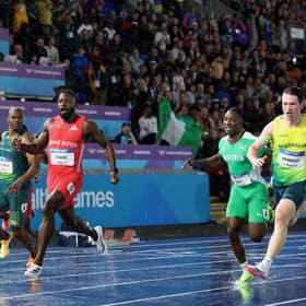 Emmanuel Eseme of Team Cameroon crosses the finish line to win the gold medal in the Men's 100 Metres Final 