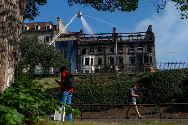 Firefighters damp down the remains of a major fire in an empty building on Princes Street on July 9 (Picture: Jeff J Mitchell)